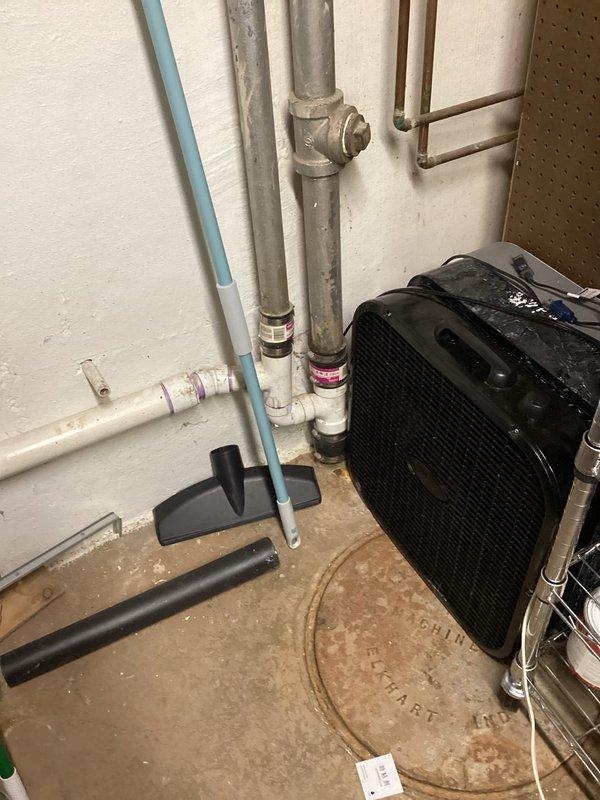 Responded to clogged laundry room sink in basement utility area. Upon inspection, located the affected drain line among the exposed plumbing infrastructure including PVC waste lines and copper supply piping. Successfully cleared the obstruction using professional drain cleaning equipment, restoring proper drainage and flow to the laundry sink. Verified system operation and confirmed no additional blockages in the drain system.