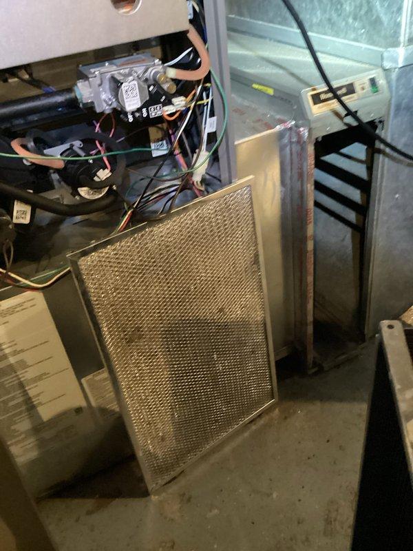 Completed comprehensive HVAC maintenance agreement service on furnace and humidifier system. Performed thorough inspection of internal components, removed and examined air filtration system showing normal wear, verified electrical connections and wiring integrity throughout unit, and documented condition of ductwork and ventilation components including curved transition vent showing dust accumulation consistent with regular operation.