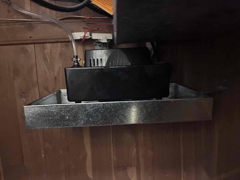 Replaced faulty safety pan beneath condensate pump unit in mechanical room. Removed old pan, installed new pan on galvanized metal platform, and verified proper drainage alignment with existing pump assembly to prevent water damage from potential overflow conditions.