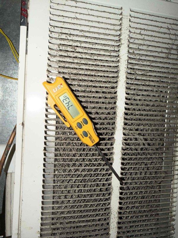 Completed comprehensive maintenance agreement service on air conditioning system, air handler, and humidifier unit #35. Performed thorough inspection and cleaning of heavily soiled evaporator coils which exhibited significant dust and debris accumulation across both coil sections. Took temperature and operational readings using digital instrumentation to verify system performance. Cleaned and inspected dirty mesh filter element removed from system. Service excluded media filter and electronic air cleaner per agreement specifications.