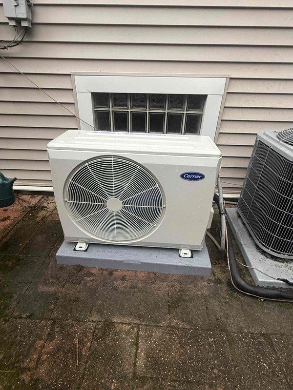 # HVAC Complete System Replacement

Successfully completed a full HVAC system replacement including furnace, condenser unit, evaporator coil, and thermostat. Removed existing equipment and installed new Carrier outdoor condensing unit on existing concrete pad with proper electrical connections and refrigerant line sets. Mounted and connected new indoor furnace with integrated evaporator coil, ensuring proper airflow and ductwork connections. Installed new digital thermostat with clear LED display showing operational temperature readings. Verified all safety labels and warning information visible on equipment per manufacturer specifications. Tested system operation, confirmed proper startup sequence, and validated temperature control functionality. All components operational and system running efficiently upon completion.