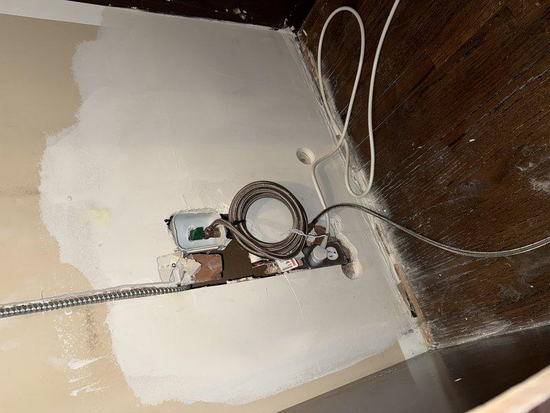 Removed wall-mounted refrigerator unit to access and inspect the water supply line behind the appliance. Upon inspection, assessed the condition of existing plumbing connections, supply valves, and flexible braided hoses for proper function and potential leaks. Documented existing wall damage and discoloration around the plumbing penetration point, noting water staining that may indicate previous supply line issues requiring further evaluation and repair.