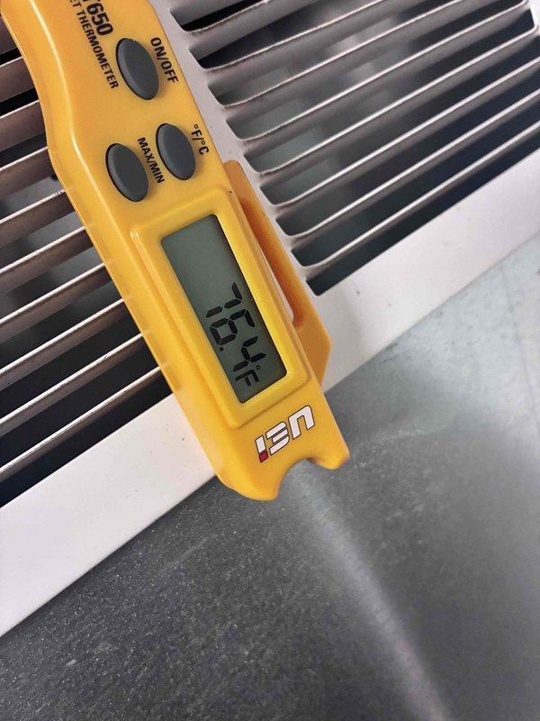 Responded to no-cooling complaint on 9-year-old downstairs AC system. Performed diagnostic assessment of outdoor condenser unit. Measured and documented system temperatures using digital thermometer, recording supply air temperature of 26.2°F at indoor unit and return air temperature of 38.7°F, indicating inadequate temperature split and insufficient cooling capacity. Inspected condenser coil condition and found fins clean and evenly spaced. Photographically documented temperature readings and equipment condition for assessment records. Provided customer with findings and prepared quote for necessary repairs to restore proper cooling operation.