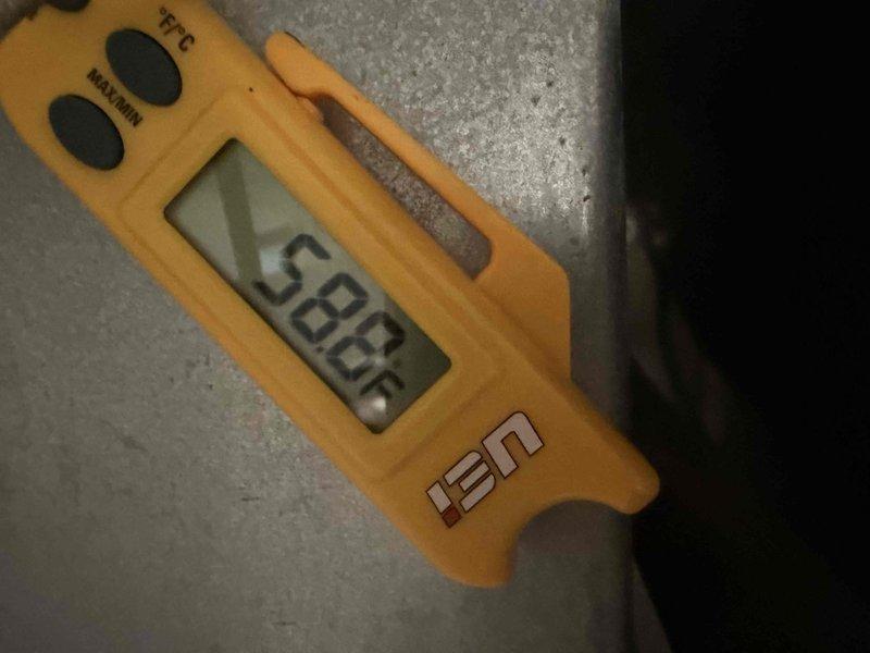 Responded to no-cooling complaint on 9-year-old downstairs AC system. Performed diagnostic assessment of outdoor condenser unit. Measured and documented system temperatures using digital thermometer, recording supply air temperature of 26.2°F at indoor unit and return air temperature of 38.7°F, indicating inadequate temperature split and insufficient cooling capacity. Inspected condenser coil condition and found fins clean and evenly spaced. Photographically documented temperature readings and equipment condition for assessment records. Provided customer with findings and prepared quote for necessary repairs to restore proper cooling operation.
