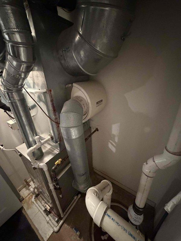 Performed comprehensive evaluation of 12-year-old HVAC system located in confined mechanical room for full system replacement estimate. Documented existing equipment configuration including air handler, ductwork, and associated plumbing components in cramped utility space. Assessed accessibility for replacement work, noting no ladder required for installation. Took measurements of available clearances and existing equipment footprint to determine proper sizing for new system. Provided detailed analysis comparing repair costs versus full system replacement options given age and condition of current equipment.