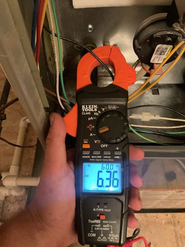 Completed comprehensive maintenance agreement inspection on residential HVAC system consisting of one air conditioning unit and one furnace located in attic space. Performed standard cleaning and maintenance procedures, including inspection and cleaning of condensate drain pan which showed significant mineral buildup and algae growth requiring attention. Conducted electrical diagnostics using clamp meter to verify proper amperage draw on blower motor circuit, recording 6.36 amps within normal operating parameters, confirming system is functioning efficiently and safely.