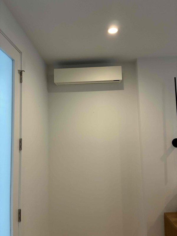 Completed full replacement of existing mini-split system with new Quilt brand ductless heat pump unit. Installed indoor wall-mounted evaporator unit in interior room near ceiling corner and positioned outdoor condenser unit on tiled patio area alongside existing HVAC equipment. Ran refrigerant lines between indoor and outdoor components, established proper electrical connections at exterior meter location, tested system operation, and verified cooling performance meets manufacturer specifications.