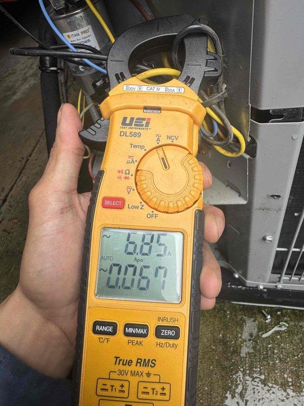 Performed preventative maintenance on condenser unit per agreement terms. Utilized digital clamp meter to measure electrical parameters including voltage readings of 734V and 1139V at disconnect, followed by amperage readings of 6.45A and 0.060A on system wiring. Inspected outdoor condenser unit, verified proper electrical connections, and confirmed system operating within normal parameters. All measurements recorded for service documentation.