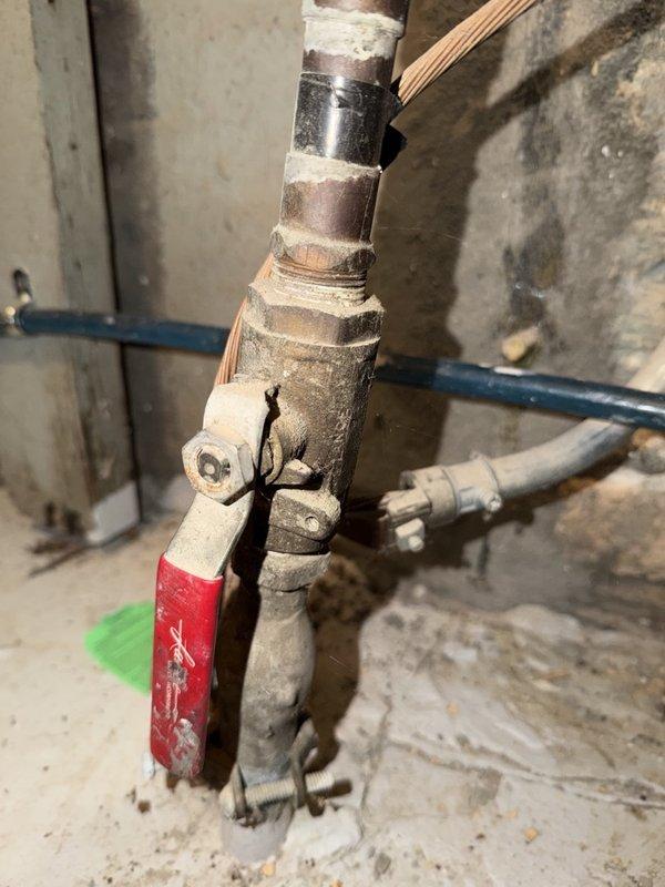 Responded to service call for NTI tankless water heater experiencing consistent water pressure loss. Upon inspection of the mechanical room installation, evaluated the complete plumbing system including copper supply lines, manifold configuration, and associated shut-off valves. Examined the tankless unit's digital control interface and verified operational parameters. Inspected all pipe connections, fittings, and isolation valves throughout the system for potential pressure restrictions or flow impediments. Assessed the condition of aging copper piping showing corrosion and mineral deposits that could contribute to pressure reduction. Checked valve operation and flow characteristics at multiple points in the distribution system. Documented existing conditions with photographic evidence showing the complete mechanical installation and specific areas of concern. Identified potential causes of pressure loss including sediment buildup, valve restrictions, or internal heat exchanger scalin