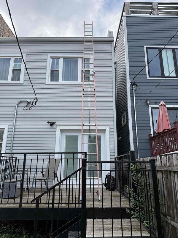 Responded to service call for air conditioning unit making unusual noise. Used telescopic extension ladder to access exterior-mounted window AC unit on second floor of residence. Upon inspection, identified source of operational sound concern. Documented condition of unit with photos and inspected return air filter, which showed moderate dust accumulation on pleated media but maintained structural integrity with proper seating in housing. Filter brand documented as Filterbuy with characteristic green border framing.