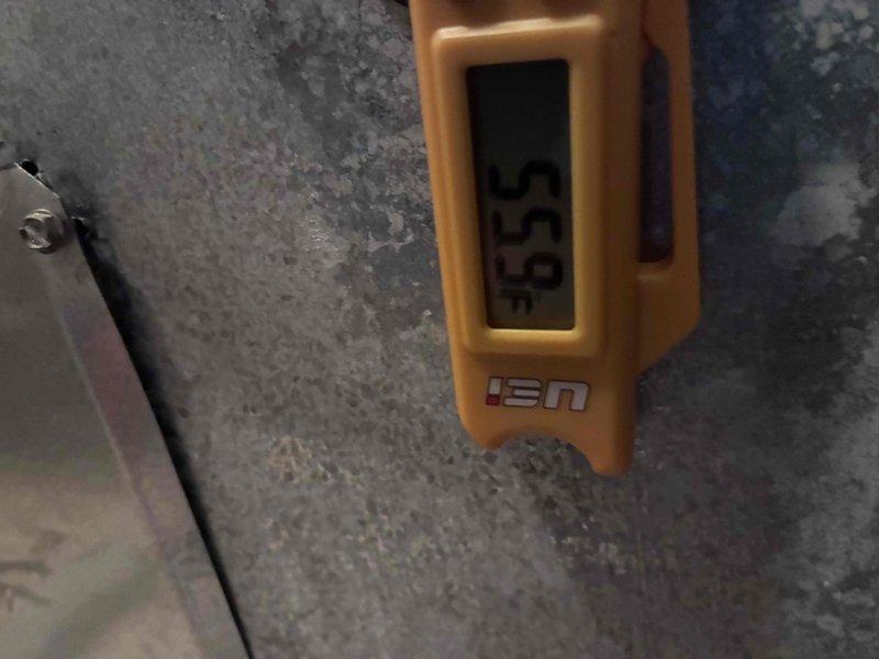 Responded to no-cooling complaint on 2-year-old residential air conditioning system. Used 8-foot ladder to access outdoor condensing unit. Upon inspection, found system inoperative due to low refrigerant charge. Utilized digital manifold gauge set to measure system pressures and confirm refrigerant deficiency. Located and repaired refrigerant leak, then evacuated system and recharged to manufacturer specifications per equipment nameplate (Model: RGGD-09EZCMS, Serial: FK5D701FA30G04650). Verified proper system operation with all electrical parameters within normal range at 12.0 amps draw. System restored to full cooling capacity. Documented equipment specifications and diagnostic readings with photos. Noted customer previously received AC tune-up in July and expressed interest in future furnace maintenance evaluation.