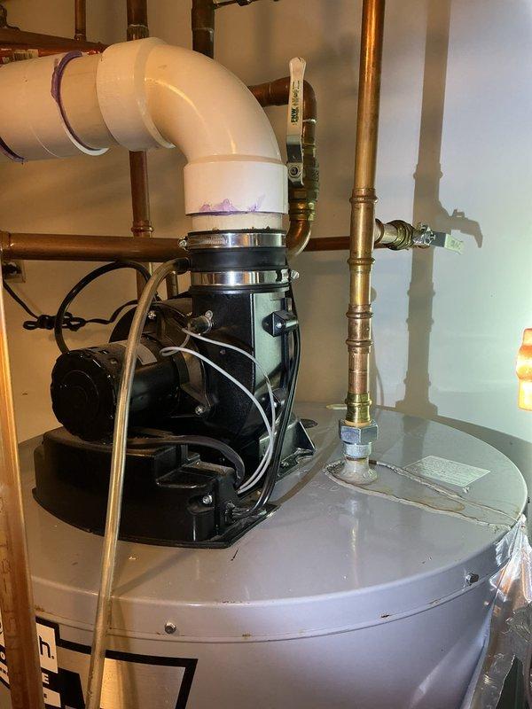 Responded to service call for leaking pipe at top of residential water heater. Upon inspection, identified active leak at copper pipe connection above the unit. Assessed circulation pump assembly and associated plumbing connections for proper installation and potential sources of the leak. Documented conditions with photographs showing the water heater installation, copper piping configuration, shut-off valves, and circulation pump assembly in the mechanical room.