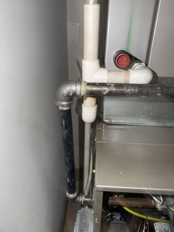 Responded to callback for gas leak on previously repaired pipe that failed People's Gas inspection. Upon arrival, inspected galvanized gas piping system showing significant corrosion and aging throughout assembly, including elbow joints, shut-off valve, and threaded connections. Documented existing conditions of deteriorated pipe work with visible rust, oxidation, and surface degradation on metal components. Photographed failed repair area and surrounding plumbing infrastructure including PVC drainage system and HVAC connections in mechanical room for further assessment and replacement recommendations.