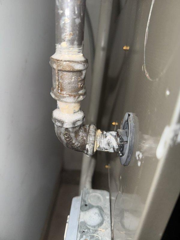 Responded to callback for gas leak on previously repaired pipe that failed People's Gas inspection. Upon arrival, inspected galvanized gas piping system showing significant corrosion and aging throughout assembly, including elbow joints, shut-off valve, and threaded connections. Documented existing conditions of deteriorated pipe work with visible rust, oxidation, and surface degradation on metal components. Photographed failed repair area and surrounding plumbing infrastructure including PVC drainage system and HVAC connections in mechanical room for further assessment and replacement recommendations.