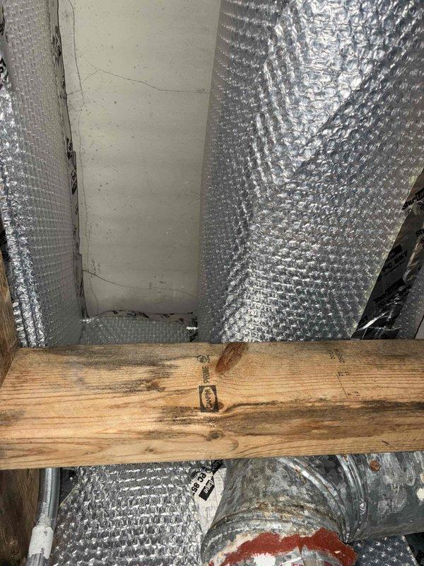 Completed insulation of accessible ductwork and plenum in commercial space using reflective bubble wrap insulation material. All exposed ductwork sections and plenum chamber were wrapped with metallic insulation to improve thermal efficiency and prevent condensation buildup. Work was performed in ceiling cavity with coordination of tenant access.