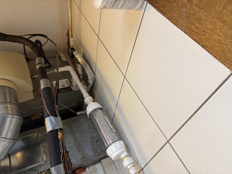 # Replace a Condensation P-Trap with Copper

Replaced the existing condensation p-trap with a new copper p-trap assembly for the HVAC system. The original trap showed signs of deterioration and required upgrading to ensure proper condensate drainage and prevent potential water damage. Installed new copper piping with appropriate fittings and connections, ensuring proper trap seal depth and venting. Verified all connections are secure and tested the system for proper drainage flow. The installation was completed in the utility area where multiple plumbing and HVAC systems converge along the wall.
