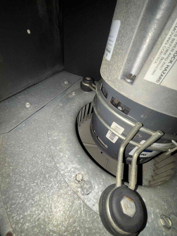 Performed comprehensive blower assembly cleaning on HVAC air handler unit. Accessed and removed accumulated dust and debris from blower motor housing, mounting base plate, and surrounding compartment surfaces. Blower motor assembly, including cylindrical motor housing with ventilation slots and curved blower wheel, was thoroughly cleaned and inspected for proper operation before reassembly.
