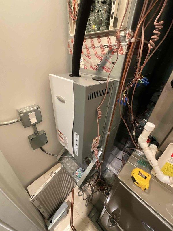 Completed comprehensive HVAC system assessment for residential property with two-floor configuration. First floor requires full system replacement due to equipment age at 15 years, including existing Triangle Tube Prestige Solo 110 ASME tankless boiler currently serving radiant heat system. Second floor air conditioning system also at 15 years of age; evaluated condenser for potential upgrade to modulating Infinity series unit to improve efficiency and performance. Documented existing equipment specifications, refrigerant line routing, electrical connections, and mechanical room configuration. Noted roof access requirements necessitating telescopic ladder for condenser evaluation and future installation work.