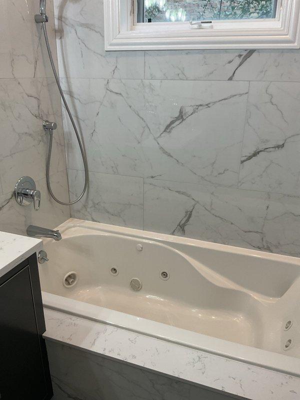 Responded to report of leak originating from bathtub and affecting the unit below. Conducted thorough inspection of jetted bathtub installation, surrounding plumbing fixtures, and under-sink areas to identify source of water intrusion. Documented existing conditions of bathroom plumbing system, including tub drain assembly, overflow connections, and jet system components, as well as kitchen disposal and drain lines to assess potential leak pathways between units.