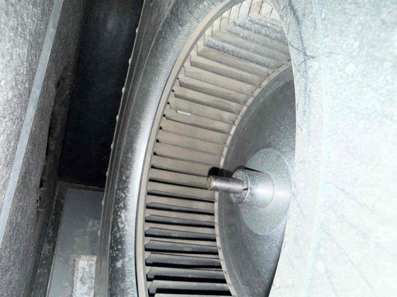 Completed preventive maintenance inspection on residential furnace system under maintenance agreement. Verified thermostat operation showing proper heating mode engagement with system actively running, inspected blower wheel assembly and housing for operational condition, and documented equipment status with photographic records for service files.
