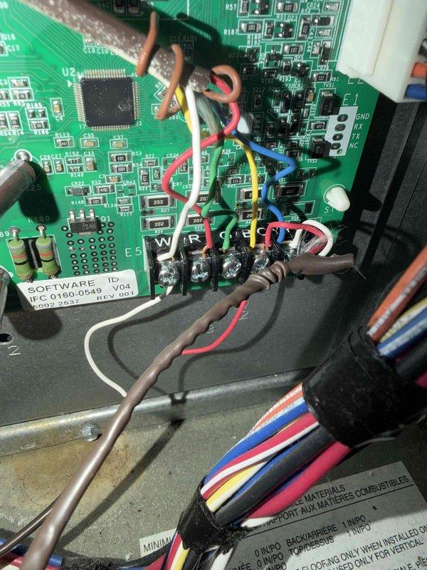 Responded to callback for AC unit continuing to short cycle after previous warranty control board and thermostat replacement. Inspected control board wiring and connections, verified proper installation of replacement board (Software ID 0160-0548 V.04), and documented internal wiring configuration and board mounting assembly. All wire terminations at control board terminal block confirmed secure with proper color coding intact. Equipment photographed for warranty documentation purposes.