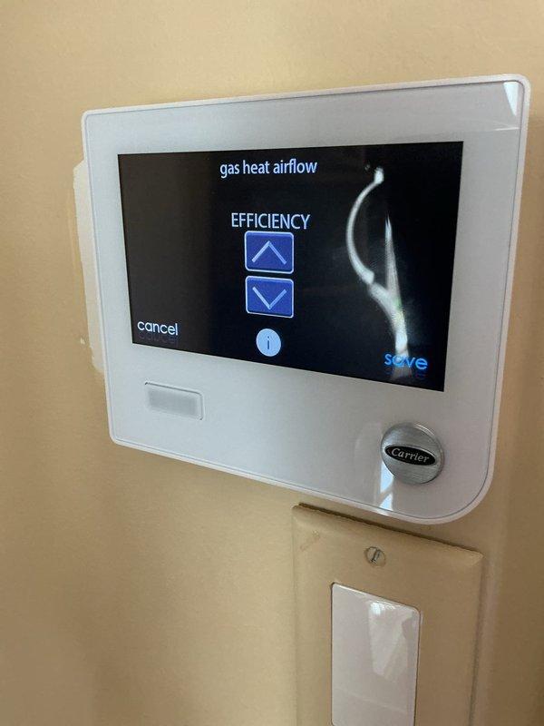 Responded to callback for recurring malfunction code 24 on basement Carrier unit that reappeared after previous day's service visit. Accessed thermostat system monitor and adjusted gas heat airflow efficiency settings to resolve the system fault error. Documented thermostat configuration changes with photos showing enable/disable toggle adjustments and airflow parameter modifications to clear the malfunction code and restore proper system operation.