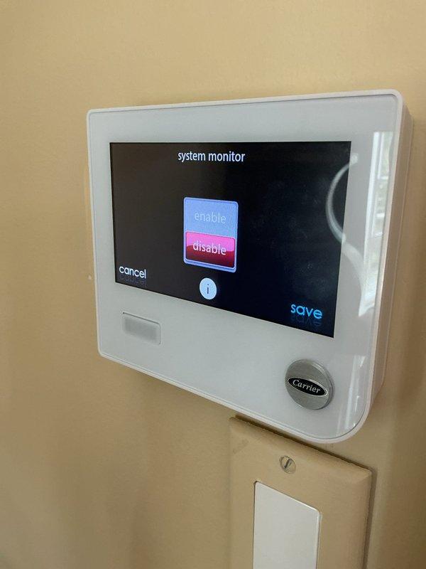 Responded to callback for recurring malfunction code 24 on basement Carrier unit that reappeared after previous day's service visit. Accessed thermostat system monitor and adjusted gas heat airflow efficiency settings to resolve the system fault error. Documented thermostat configuration changes with photos showing enable/disable toggle adjustments and airflow parameter modifications to clear the malfunction code and restore proper system operation.