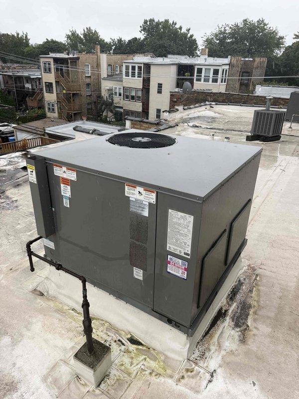 Responded to no cooling call with reported loud noise from rooftop packaged HVAC unit. Upon arrival, inspected 6-year-old air handler and rooftop RTU installation. Performed diagnostic assessment of unit operation, examined fan assembly and motor components through top grille access. Evaluated condenser fan guard, motor mounting, and internal components for abnormal wear, debris, or mechanical issues causing excessive noise. Documented equipment condition with photos showing rooftop unit placement, fan assembly configuration, and overall system installation for service records.