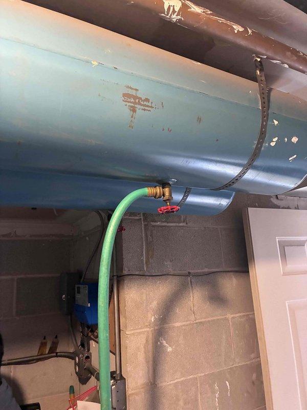 Completed commercial preventative maintenance inspection on boiler system in accordance with maintenance agreement. Documented existing conditions including water heater tank showing significant rust deterioration and corrosion, along with drainage system components and boiler room grating displaying oxidation and mineral buildup. All observations photographed for maintenance records, and boiler room access code confirmed for future service calls.