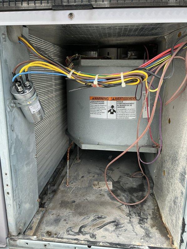 Completed comprehensive heating maintenance on commercial rooftop unit #1 per agreement terms. Performed thorough inspection of heating components, electrical connections, and gas-fired sections. Documented equipment condition with interior cabinet access revealing operational coil assembly, capacitor, and control box with proper safety labeling intact. Exterior inspection showed weathered copper refrigerant lines with oxidation and unit mounted on concrete pad with standard environmental wear. All heating components found operational and system left in serviceable condition.