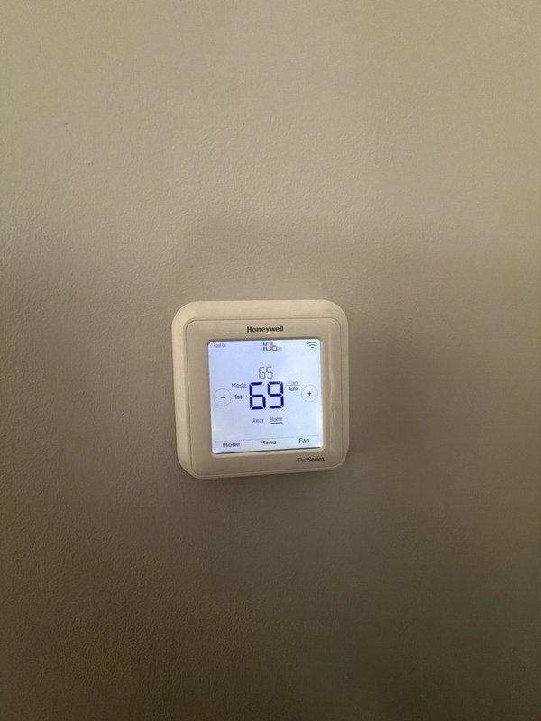 Completed comprehensive maintenance agreement service on two residential air conditioning systems. Performed thorough inspection of Carrier furnace, associated humidifier unit, and connected HVAC components in mechanical room. Verified proper operation of thermostat control system, which was maintaining setpoint at 65 degrees with current temperature reading of 69 degrees. Inspected all copper refrigerant lines, PVC drainage and ventilation piping, electrical conduits, and system connections for proper installation and functionality. Documented equipment conditions through photography for maintenance records.