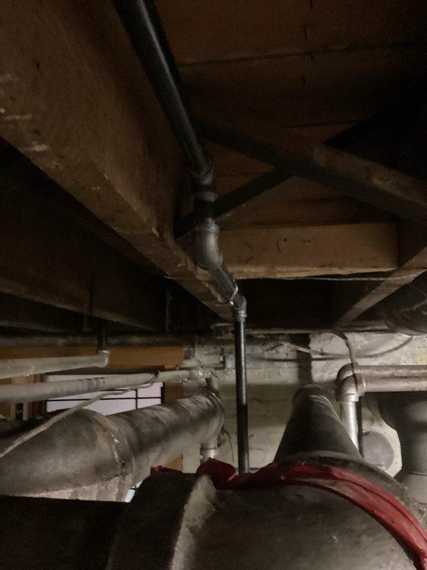 Completed comprehensive gas line replacement throughout the property, removing outdated piping and installing new code-compliant gas distribution system. Work involved routing new black iron pipe through basement ceiling joists, making necessary connections to existing HVAC equipment and appliances, and ensuring proper support and clearances from other building systems including PVC drainage lines and insulated ductwork.
