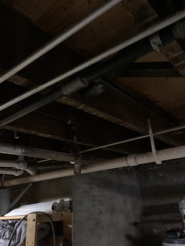 Completed comprehensive gas line replacement throughout the property, removing outdated piping and installing new code-compliant gas distribution system. Work involved routing new black iron pipe through basement ceiling joists, making necessary connections to existing HVAC equipment and appliances, and ensuring proper support and clearances from other building systems including PVC drainage lines and insulated ductwork.