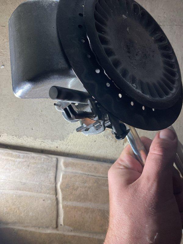 Responded to no hot water complaint on residential water heater. Upon inspection, found failed inducer motor assembly preventing unit operation. Removed defective blower motor from combustion chamber, which showed signs of dust accumulation and mechanical wear. Replaced inducer motor assembly and verified proper operation of gas control valve and venting system. Tested unit for proper ignition sequence and confirmed hot water restoration.