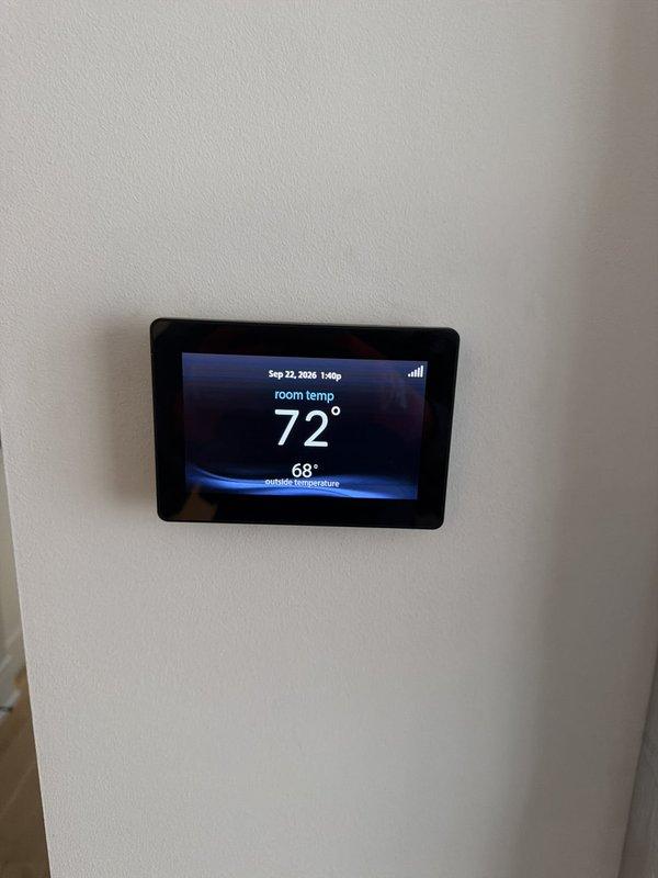 Completed preventive maintenance agreement service on residential HVAC system with dual condensers. Inspected and serviced both outdoor condensing units, replaced air filter at furnace, and verified thermostat operation showing proper temperature control at 72°F room temperature. All equipment found operating within normal parameters.