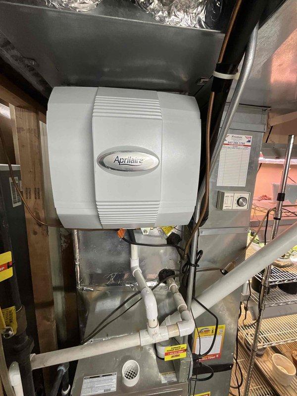 Completed comprehensive estimate for air conditioning system and ductwork modifications to accommodate installation of media filter cabinet. Assessed existing York furnace installation and current ductwork configuration in basement utility area to determine optimal placement and integration points for enhanced filtration system. Documented existing HVAC infrastructure including Aprilaire whole-house humidifier, supply and return ductwork, and electrical connections. Evaluated ductwork routing and structural requirements necessary for proper media filter cabinet installation while maintaining system efficiency and airflow specifications. Photographed equipment layout and existing components to provide detailed reference for proposed modifications and material requirements.