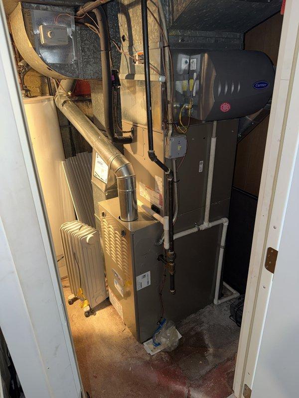 Completed comprehensive maintenance agreement service on Carrier furnace and whole-home humidifier system in basement mechanical area. Performed standard seasonal inspection including filter replacement with 16x25x1 media filter, verified humidifier operation and water supply connections, inspected ductwork connections and electrical components, and documented equipment condition with photographic records. All systems operating within manufacturer specifications with no deficiencies noted.