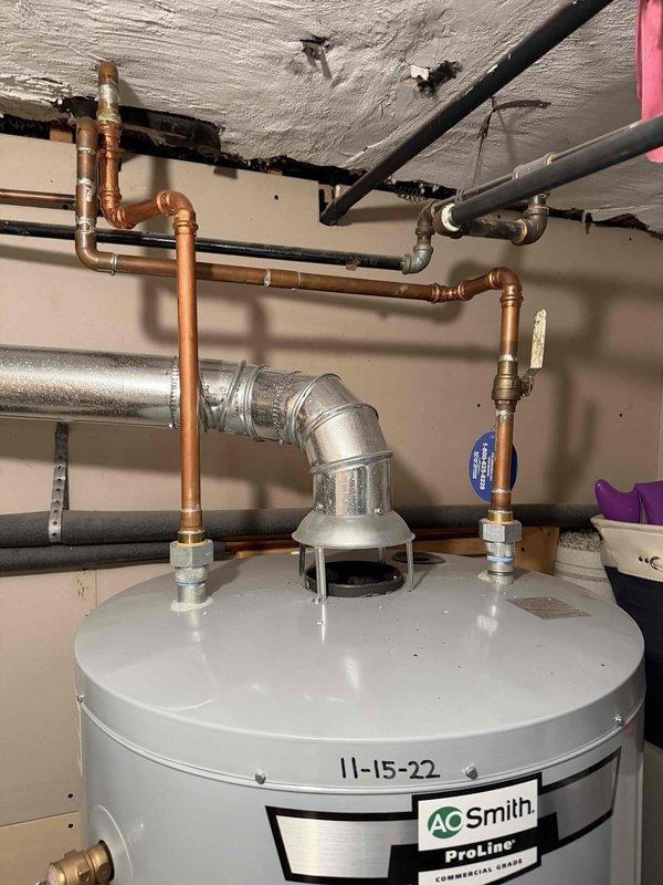 # Tanked Water Heater Repair

Responded to service call for water heater producing knocking noises. Upon inspection, identified an AO Smith ProLine commercial grade unit with date marking of 11-15-22. Diagnosed knocking sounds as sediment buildup causing water hammer effect within the tank. 

Performed tank flush procedure to remove accumulated mineral deposits and sediment from bottom of tank. Inspected all plumbing connections, copper supply lines, and shut-off valves for proper operation. Verified temperature and pressure relief valve functionality. Tested unit operation after service and confirmed elimination of knocking noises. All connections secure and system operating within normal parameters.