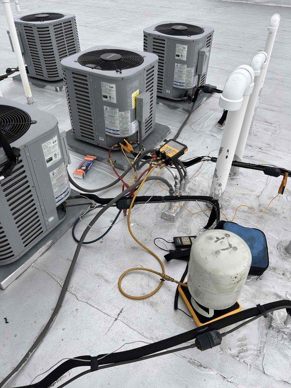 Responded to no-cool call for rooftop AC unit experiencing freezing condition. Upon inspection, found significant mineral buildup and crystallization around refrigerant line connections indicating moisture intrusion at valve assembly. Connected gauges and performed system diagnostics, identifying restricted refrigerant flow due to corroded valve and ice formation on evaporator coil. Cleaned affected connections, addressed moisture contamination, and restored proper system operation with normal cooling capacity.