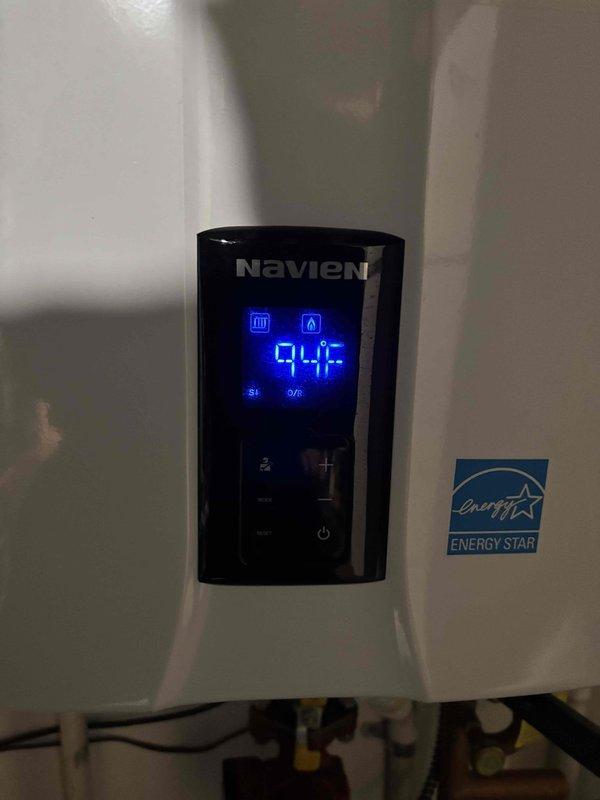 Performed comprehensive maintenance on two Navien tankless water heaters and one conventional storage water heater under agreement terms. Inspected heating elements, electrical connections, and terminal blocks for proper operation and signs of wear. Verified digital control panel functionality on tankless units, confirming accurate temperature readings at 94°F and proper display operation. Documented equipment condition with photos showing component integrity and Energy Star certified unit performance. All systems operating within normal parameters.
