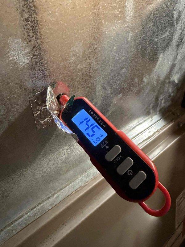 Performed preventive maintenance inspection on furnace system under maintenance agreement. During inspection, discovered significant ice buildup on evaporator coil with temperature reading of 14.2°F, indicating potential refrigerant flow restriction or airflow deficiency. Documented equipment condition including condensate management components and verified manufacturer specifications on unit labels. Captured diagnostic imagery showing extent of coil frosting and internal component configuration for maintenance records.