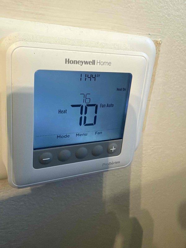 Completed comprehensive maintenance agreement inspection on single furnace system. Performed thorough examination of blower wheel assembly, noting normal dust accumulation on impeller and age-appropriate patina on radial fins consistent with regular operation. Verified Honeywell ProSeries thermostat functionality, confirming proper heating mode operation with system actively calling for heat and fan set to auto mode. Filter media replacement not included in this service visit per agreement specifications.