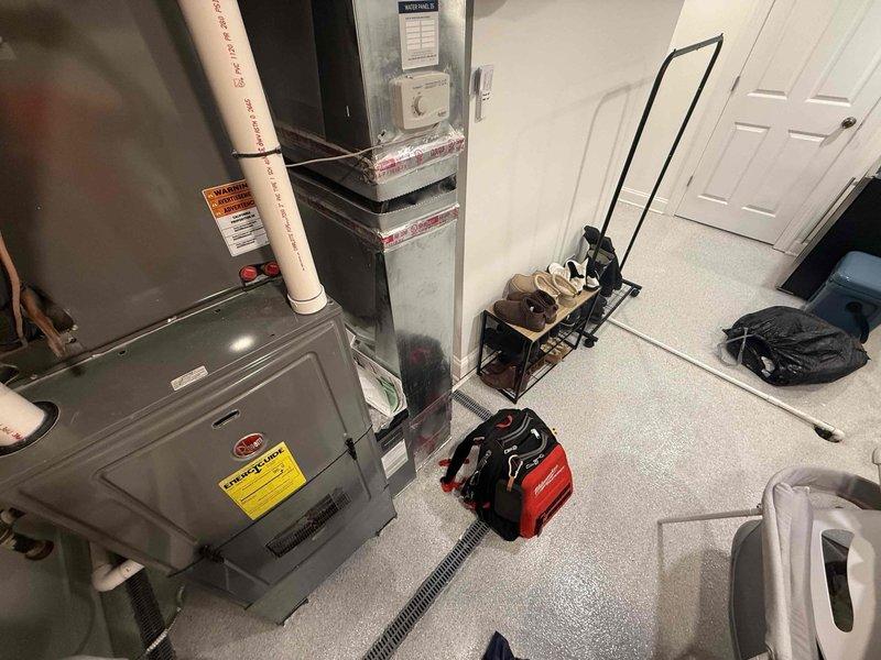 Responded to no heat call on residential furnace system. Upon arrival, found furnace in utility room with previous service history for same issue. Performed diagnostic evaluation of heating system including visual inspection of unit components, electrical connections, and gas supply. Verified thermostat operation and system controls. Checked ignition sequence, flame sensor, and burner assembly operation. Inspected heat exchanger, blower motor, and air filter condition. Tested safety switches including pressure switches and limit controls. Examined venting system and condensate drain for proper operation. Documented equipment condition with photos showing furnace installation, surrounding workspace, and relevant system components. System evaluated and appropriate recommendations provided to restore heating function.