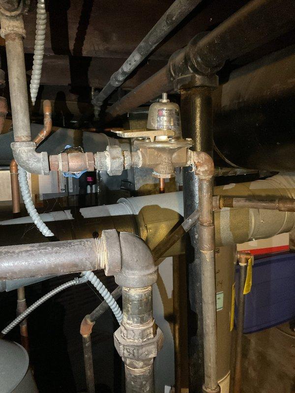 Completed comprehensive boiler maintenance and inspection as part of annual agreement service. Inspected and documented all system components including pressure regulator valve, circulator pump operation, and associated piping connections. Verified proper operation of red-cased circulator pump with all electrical connections secure, confirmed adequate flow through copper supply and return lines, and assessed condition of pressure reducing valve and related plumbing infrastructure in mechanical space.