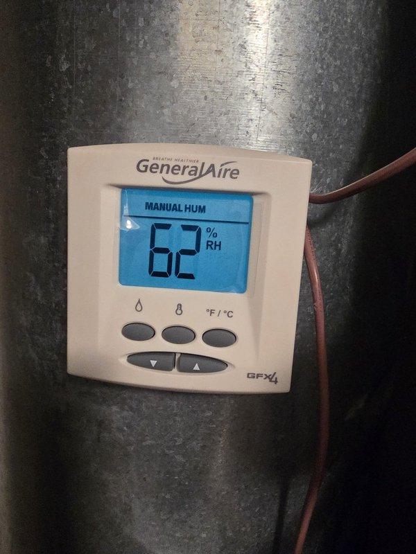 Returned to heat pump installation site to complete warranty work by installing additional wiring kit. Added control wiring to enable proper heat pump operation and integrated humidistat controls with the HVAC system. Verified proper communication between thermostat, heat pump unit, and humidity control components, with digital humidistat displaying correct readings at 62% RH in manual mode.