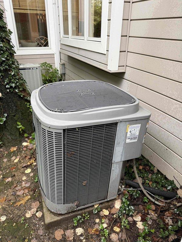 Responded to indoor air quality concern regarding high humidity levels remaining above 81 percent in residence with approximately 30-year-old Trane XE 1000 cooling system. Performed diagnostic assessment of outdoor condensing unit and documented equipment condition with photos showing weathered but operational unit positioned on concrete pad with visible dirt accumulation on cabinet panels. Given the age of the system and persistent humidity control issues, recommended evaluation of dehumidification capacity and potential system upgrades to address IAQ concerns effectively.