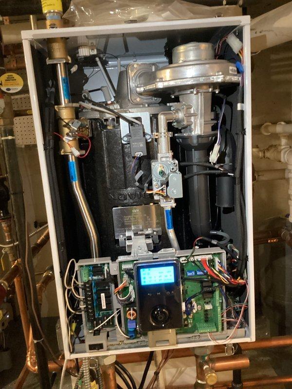 Performed comprehensive maintenance on wall-mounted combination tankless boiler and water heater system. Removed front access panel and inspected all internal components including blower assembly, heat exchanger, gas valve, circuit boards, and digital control interface. Verified proper operation of manifold system with pressure gauges, expansion tanks, and isolation valves. All mechanical and electrical components found in satisfactory working condition with no issues identified.