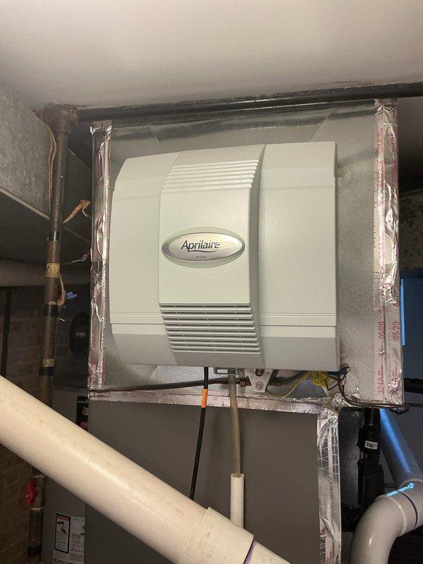 Completed comprehensive maintenance agreement service on furnace, humidifier, and water heater system. Performed thorough inspection of Aprilaire humidifier unit integrated within HVAC ductwork, verifying proper operation and connections of water supply lines including copper and PVC piping. Documented temperature readings of 115.3°F at water heater using calibrated digital thermometer, confirming proper heating performance. Inspected all accessible components, ductwork insulation, and mechanical connections to ensure system integrity and compliance with maintenance agreement parameters.