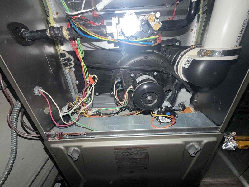 Completed comprehensive maintenance agreement service on residential gas furnace system. Performed thorough cleaning and inspection of unit, replaced 20x25x1 air filter, verified proper burner operation with clean blue flame pattern across all ports, and confirmed blower motor assembly functioning correctly. Documented system condition with interior component photography showing heat exchanger, gas valve assembly, electrical connections, and blower motors all operating within normal parameters.