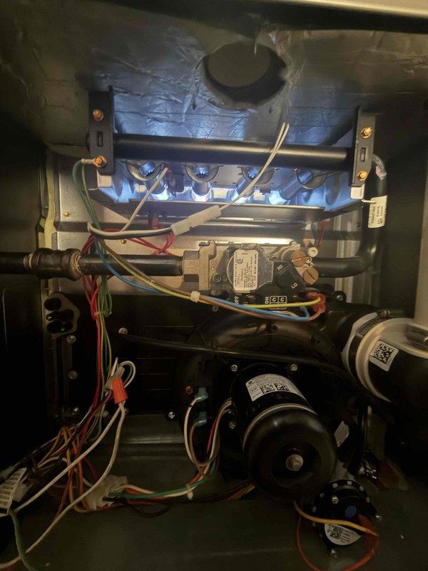 Completed comprehensive maintenance agreement service on residential gas furnace system. Performed thorough cleaning and inspection of unit, replaced 20x25x1 air filter, verified proper burner operation with clean blue flame pattern across all ports, and confirmed blower motor assembly functioning correctly. Documented system condition with interior component photography showing heat exchanger, gas valve assembly, electrical connections, and blower motors all operating within normal parameters.